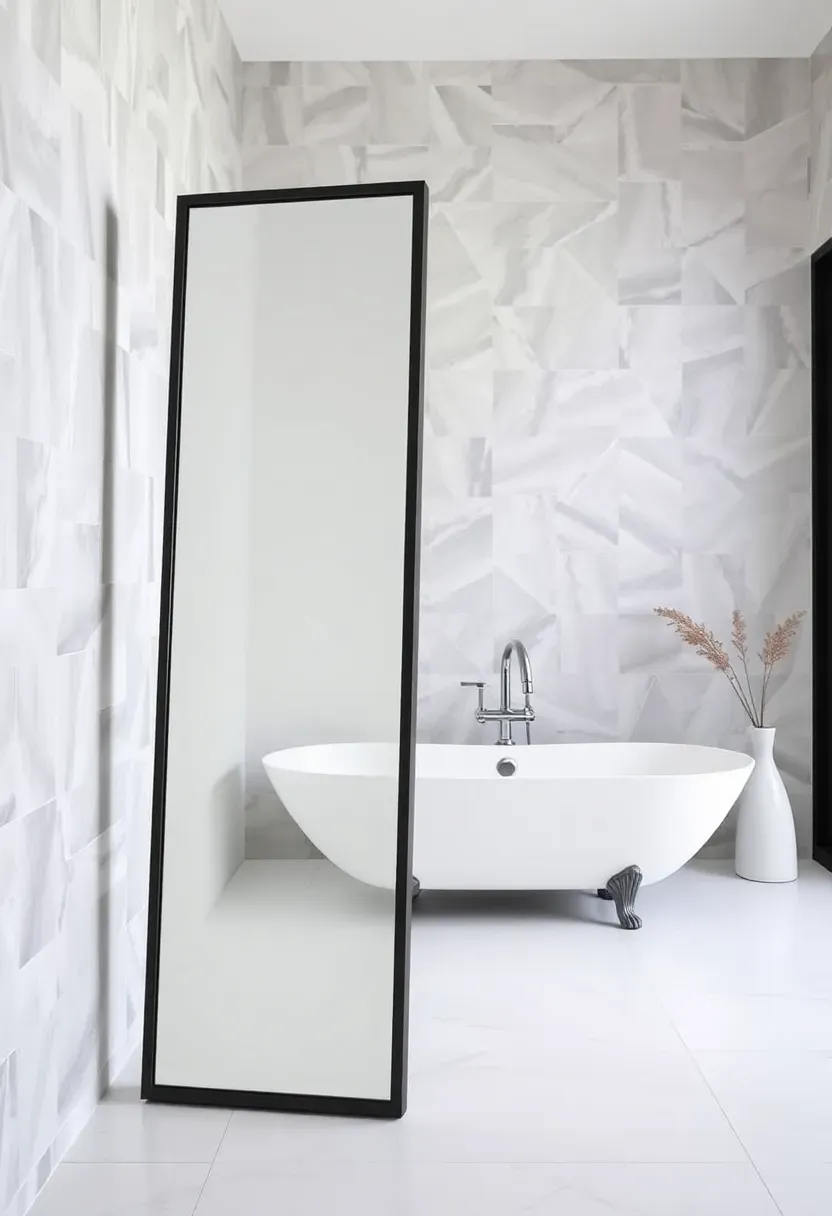 Full-length leaning bathroom mirror in a thin black frame propped against a tiled wall in a spacious bathroom with a freestanding tub